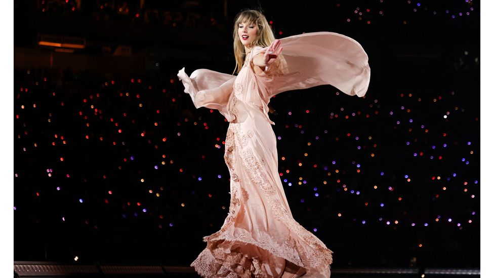 During the Folklore section of her current Eras tour, Taylor Swift has been sporting a selection of 70s-inspired dresses on stage (Credit: Getty Images)