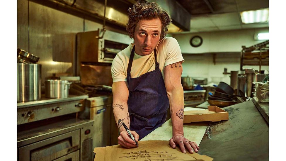 Chef Carmy (Jeremy Allen White) wears a crisp, indigo denim apron in The Bear (Credit: Disney+/ FX)