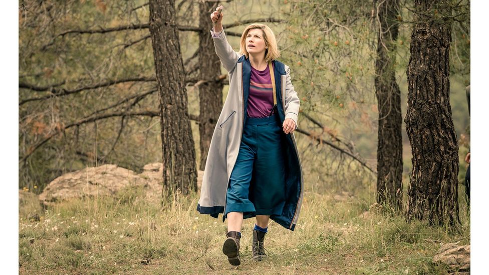 The rainbow stripes, cropped trousers and clompy boots of Jodie Whittaker's ensemble was in opposition to the previous Doctor's look (Credit: BBC Studios)