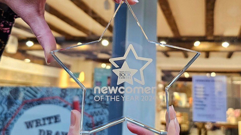 Clear star-shaped plaque showing newcomer of the year