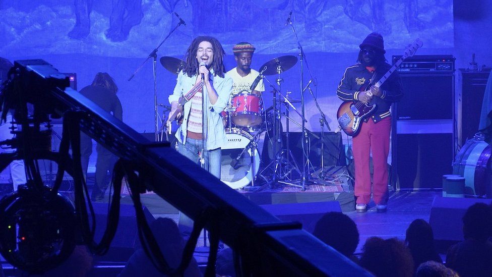 A behind-the-scenes shot of the One Love film, showing actor Kingsley Ben-Adir onstage in Alexandra Palace