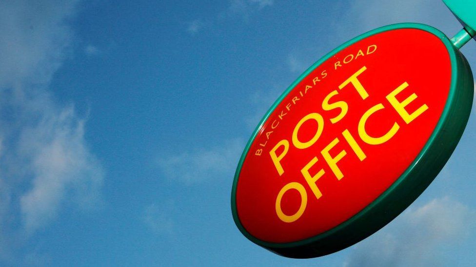 Post Office sign on a background of blue sky