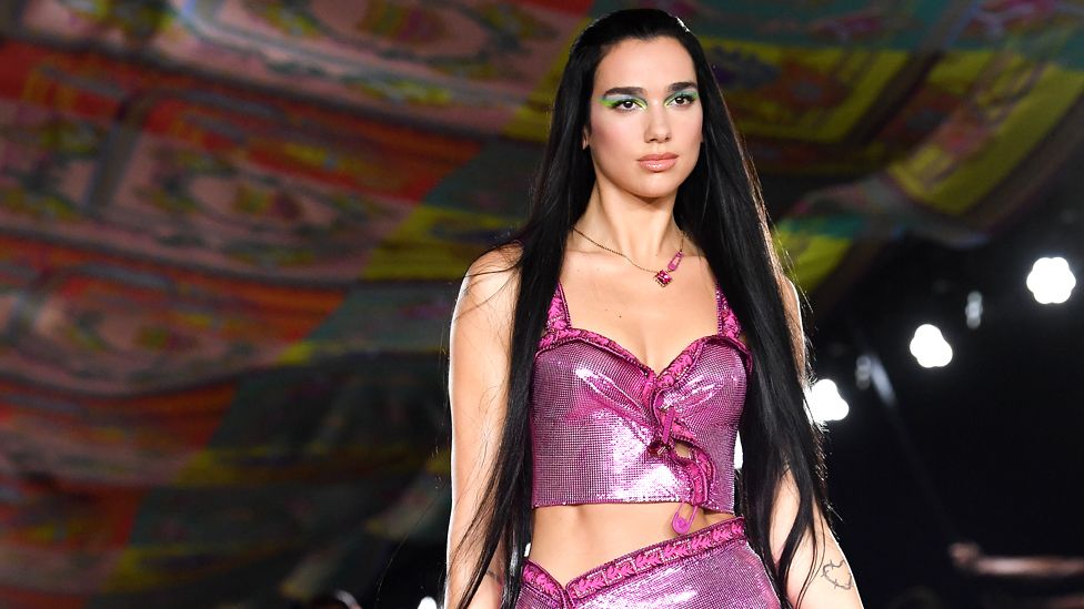 Dua Lipa walks the runway at the Versace fashion show during the Milan Fashion Week on 24 September 2021 in Milan, Italy