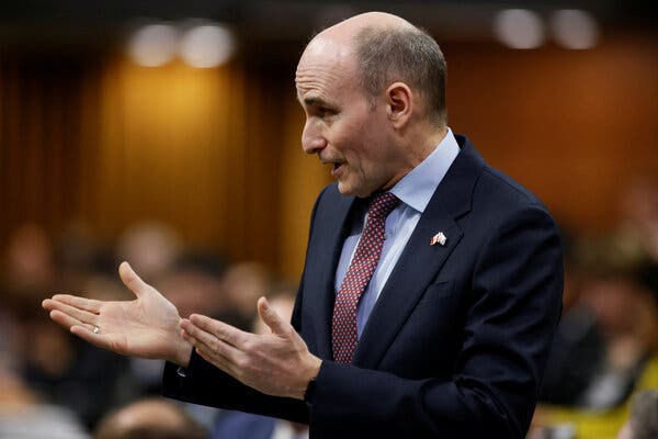 Jean-Yves Duclos, wearing a suit, gestures with both hands as he speaks before Parliament.