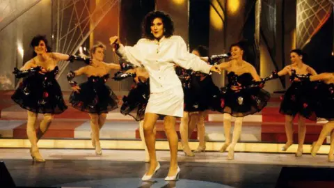 Getty Images Celine Dion on stage in front of dancers at the 1988 Eurovision Song Contest