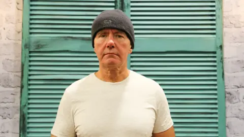 Author Irvine Welsh looks square into the camera