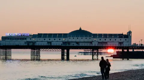 Getty Images Brighton Pier with the sun setting below it