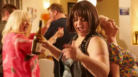 BBC/Toffee International Ltd./Tom Jackson Gavin (MATHEW HORNE), Pam (ALISON STEADMAN), Smithy (JAMES CORDEN), Nessa (RUTH JONES), Stacey (JOANNA PAGE) partying in the finale of Gavin & Stacey