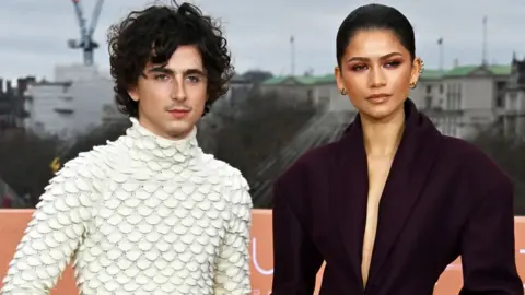 Getty Images Timothée Chalamet (L) and Zendaya attend the London photocall for Dune: Part Two at IET London on 14 February. Chalamet is wearing a cream polo-neck covered in half disc shapes, while Zandaya has an oversized black jacket on with a deep V-neck.