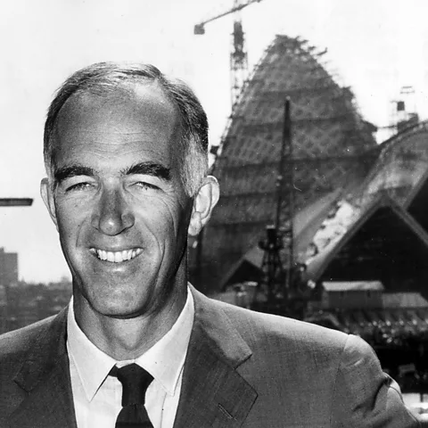 Getty Images Danish architect Jørn Utzon in front of his under-construction creation – he resigned from the project in 1966, and never saw it completed (Credit: Getty Images)