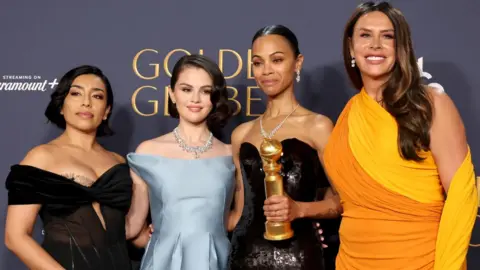 Getty Images (L-R) Adriana Paz, Selena Gomez, Zoe Saldana, winner of the Best Performance by a Female Actor in a Supporting Role in Any Motion Picture award for “Emilia Pérez,” and Karla Sofía Gascón pose in the press room during the 82nd Annual Golden Globe Award at The Beverly Hilton on January 05, 2025 in Beverly Hills, California