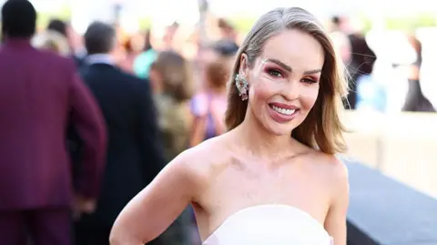 Getty Images Katie Piper at the Bafta TV awards 2025, wearing a strapless white gown.