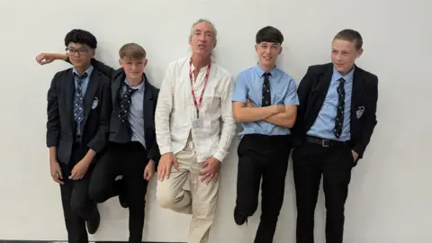 St James' C of E High School Mike Garry with students from Farnworth High School