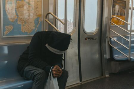 Person reading on public transportation during morning commute