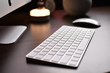 Why Mechanical Keyboards Are Taking Over Creative Professional Workspaces Professional workspace with mechanical keyboard on desk with monitor and creative tools