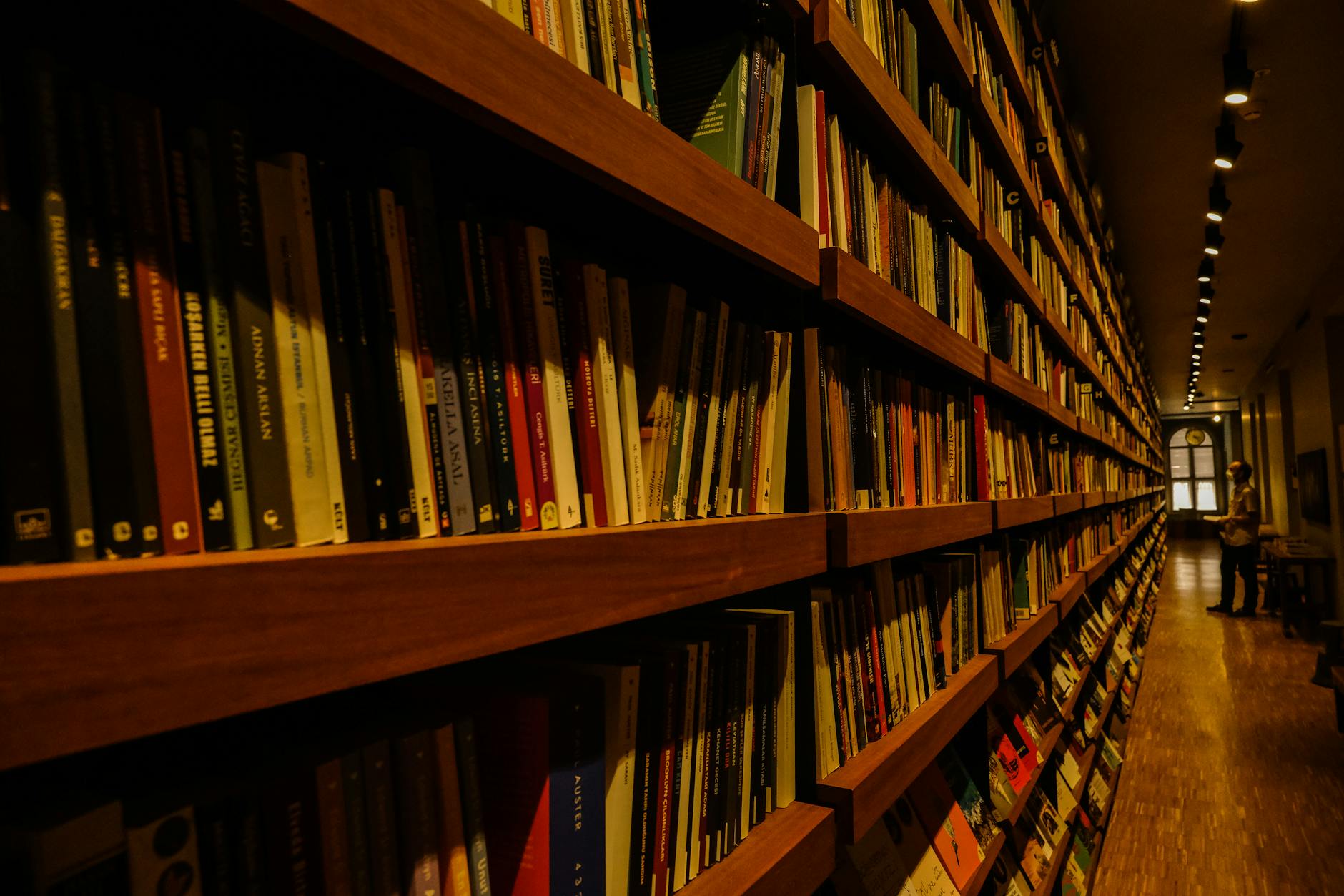 Interior view of bookstore with shelves of mystery novels and cozy reading areas