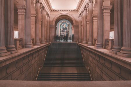 How Museum Late-Night Events Are Drawing Younger Diverse Crowds Modern museum interior with ambient lighting and people socializing during evening event