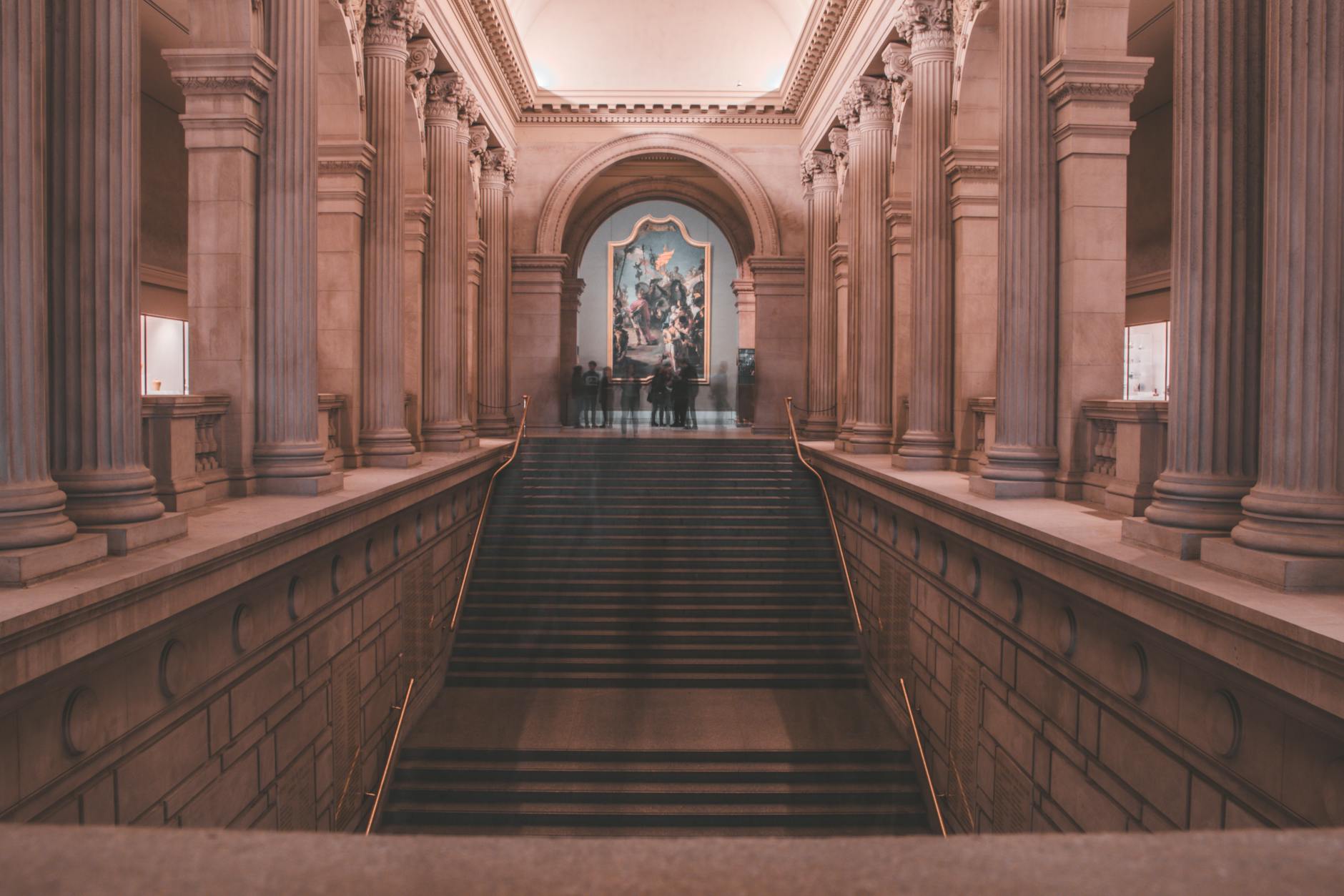 Modern museum interior with ambient lighting and people socializing during evening event