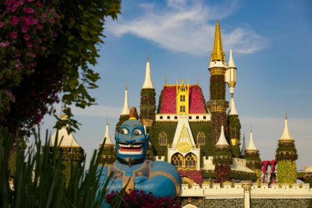 How Fantasy Authors Are Building Theme Parks Around Their Worlds Fantasy castle structure in a theme park setting with visitors walking nearby