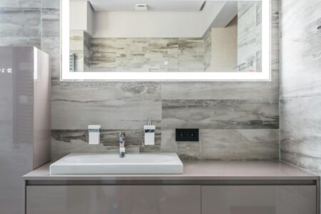 Modern bathroom with large mirror and LED lighting