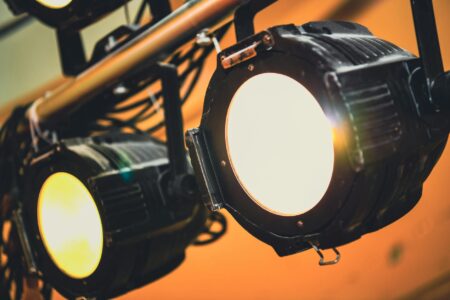 Why Stand-Up Comics Are Opening Permanent Theater Residencies Empty theater stage with dramatic stage lighting and red curtains