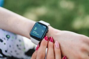 Why Fitness Trackers Are Adding Mental Health Monitoring Features Person wearing a modern fitness tracker on their wrist displaying health metrics