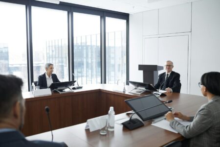 Corporate team gathered around conference table during business meeting