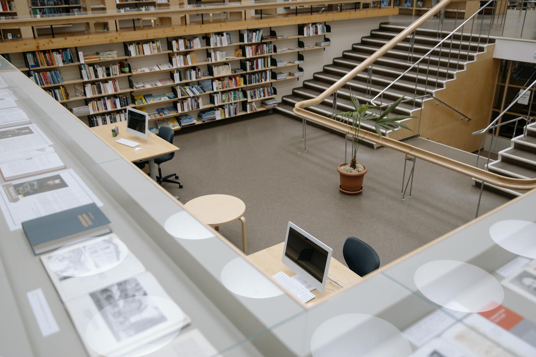 Modern library interior with computers and collaborative workspace areas