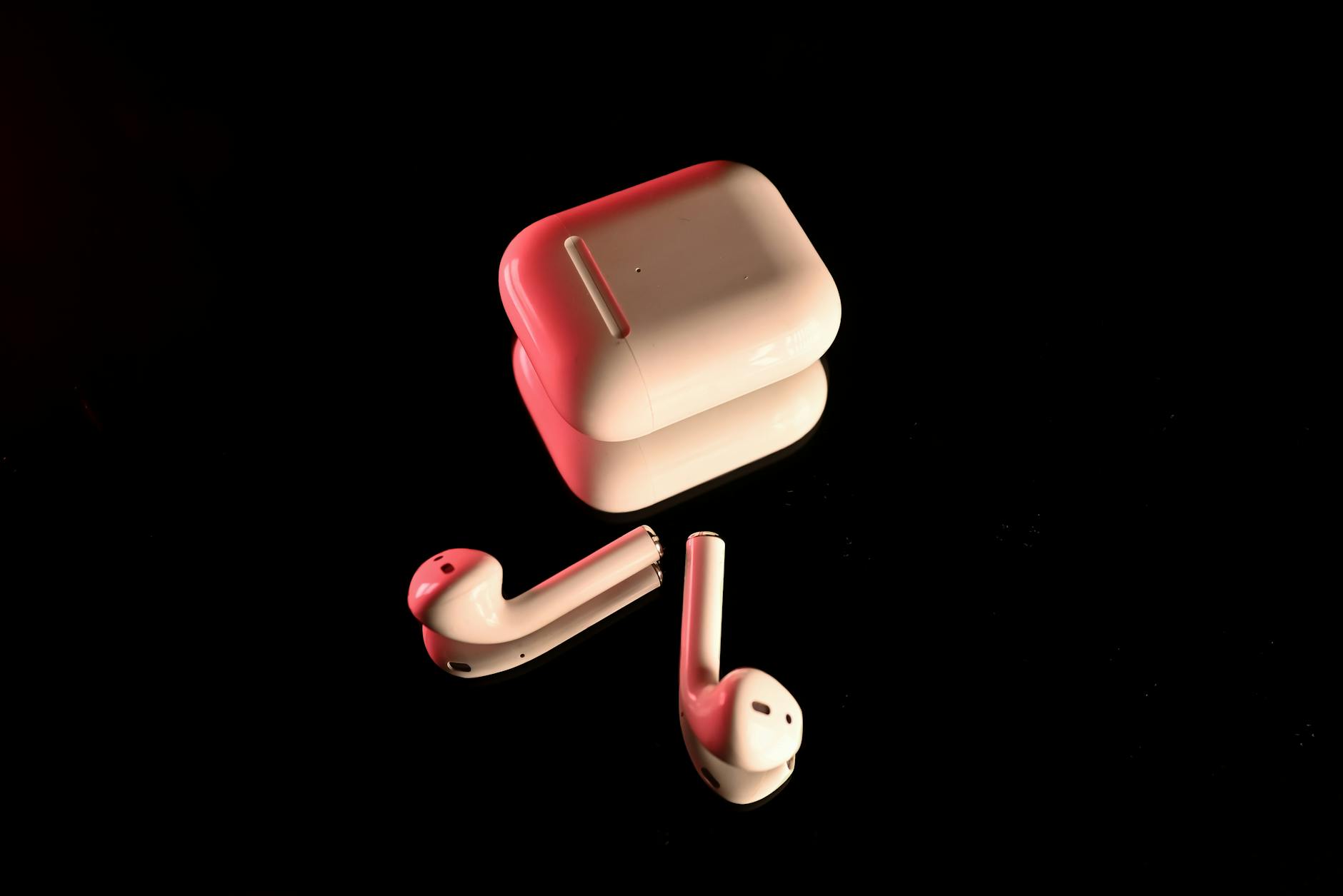 Modern wireless earbuds on a white surface showing sleek design and charging case