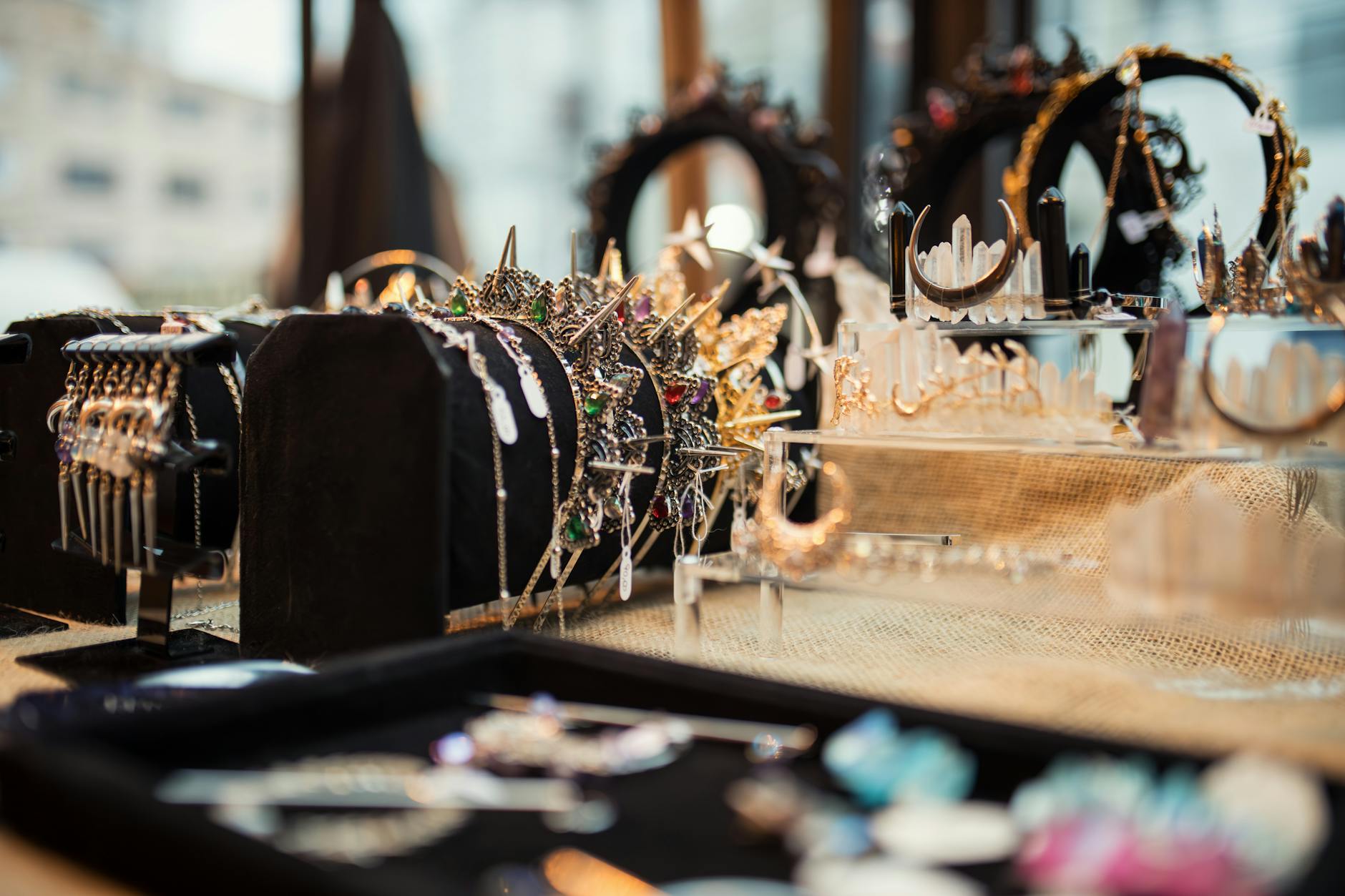 Close-up of delicate gold jewelry pieces including rings and earrings on white background