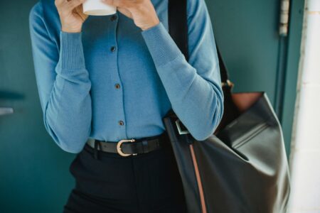Professional woman wearing an oversized cardigan in a modern office setting