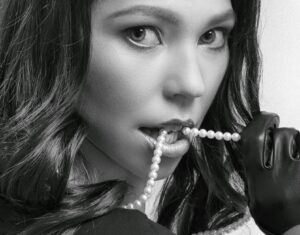 Elegant pearl necklace and earrings displayed on white background showing classic jewelry styling