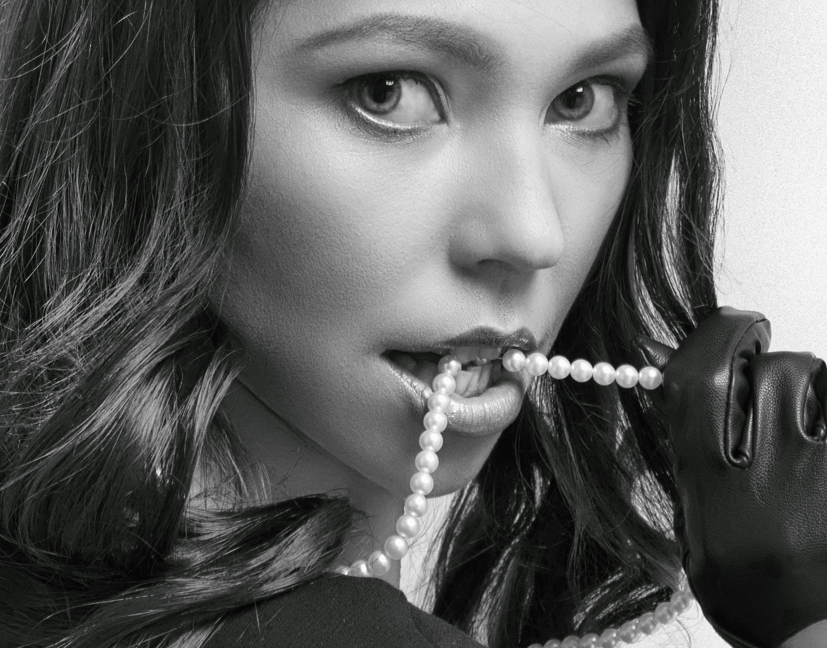 Elegant pearl necklace and earrings displayed on white background showing classic jewelry styling