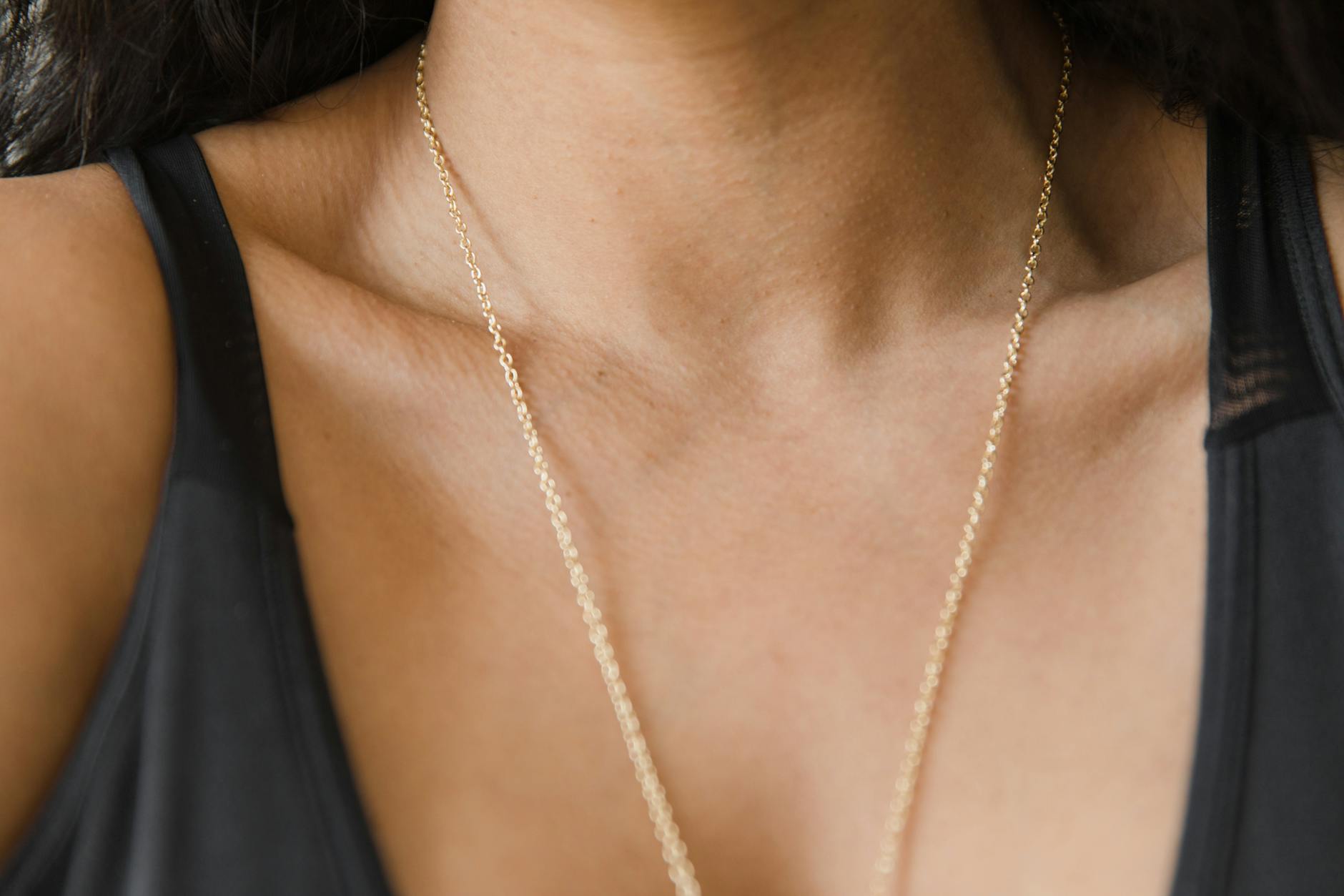Close-up view of chunky gold chain necklace on professional attire