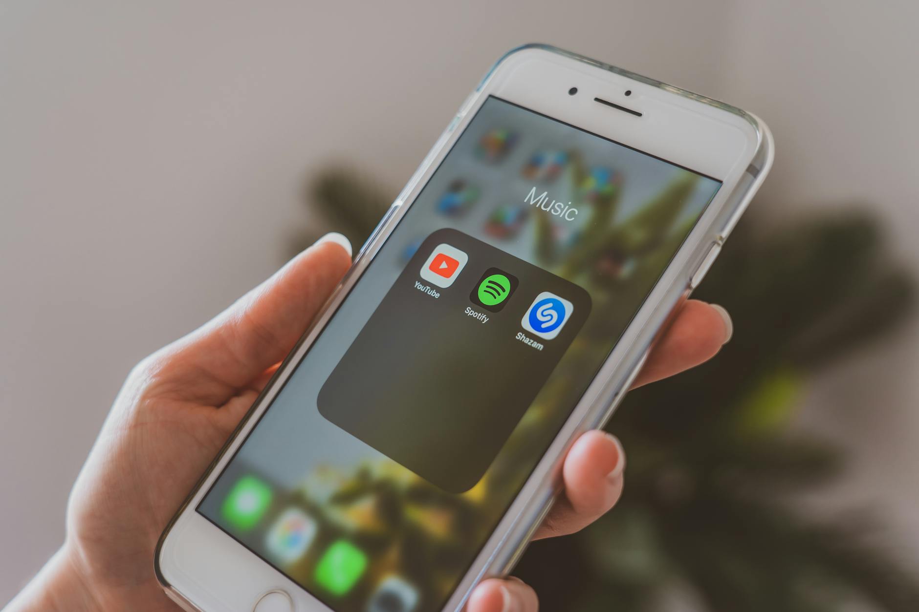 Close-up of smartphone displaying music streaming app interface with playlists and recommendations