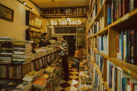 Cozy independent bookstore interior with wooden shelves lined with books and comfortable reading areas