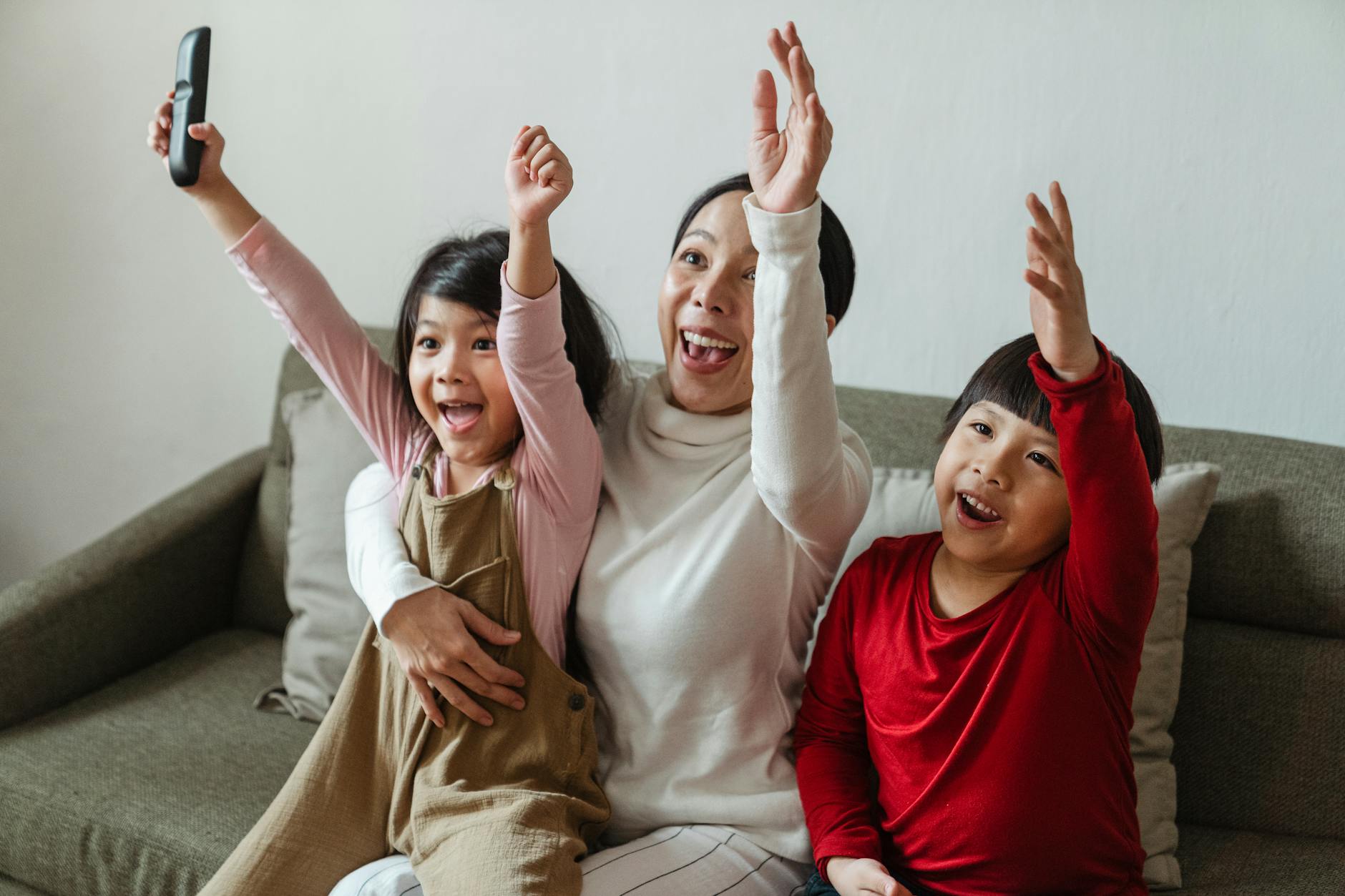 Family gathered together watching television in living room