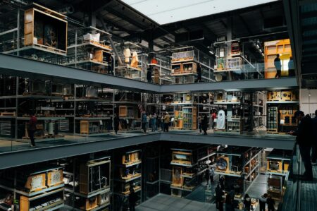 Modern museum gallery space with white walls and contemporary art installations during evening lighting