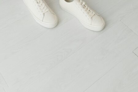 Clean white sneakers representing sustainable footwear design and minimalist aesthetic
