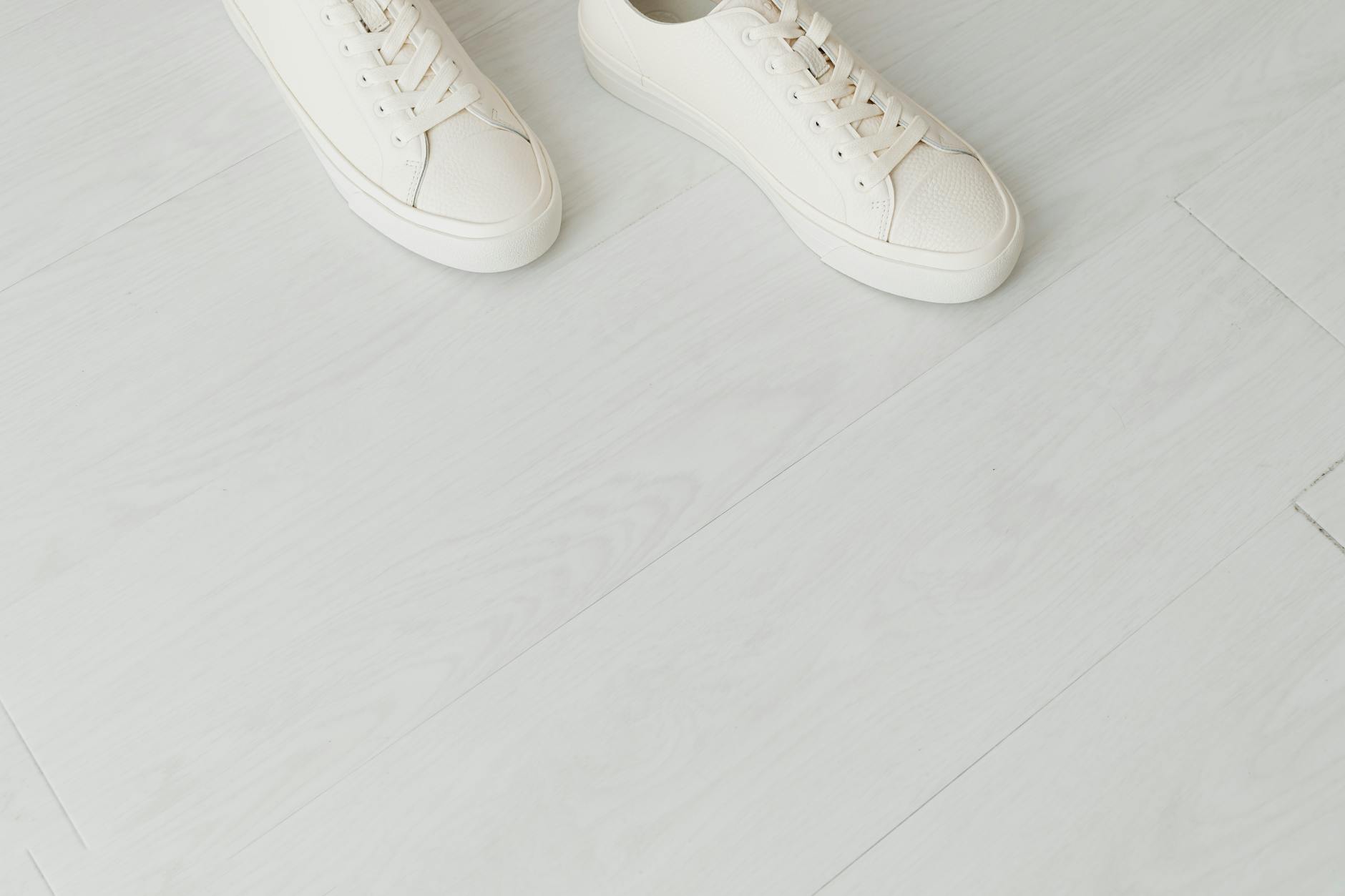 Clean white sneakers representing sustainable footwear design and minimalist aesthetic