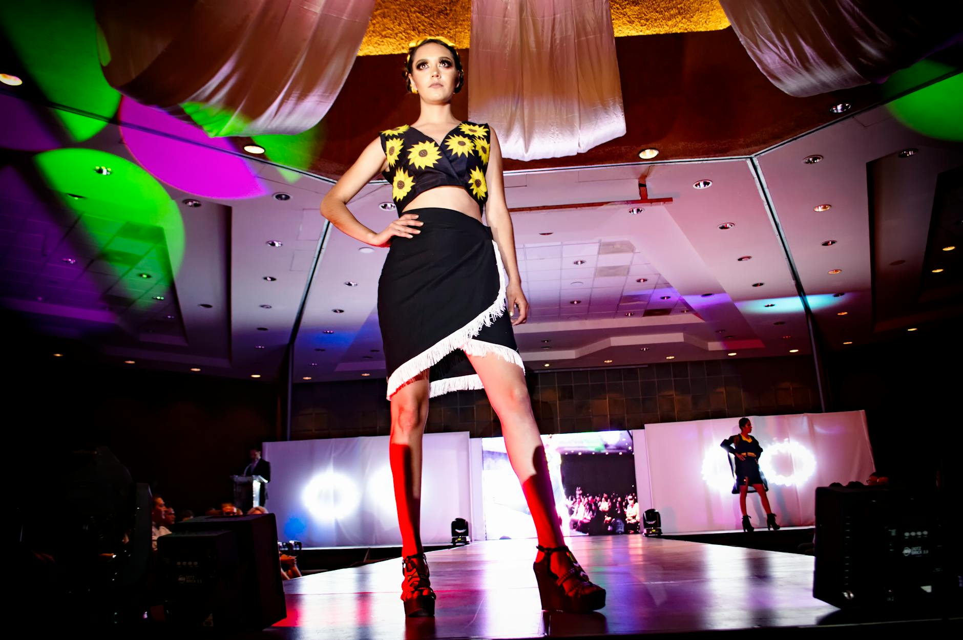 Models walking on fashion runway showcasing designer footwear collaborations