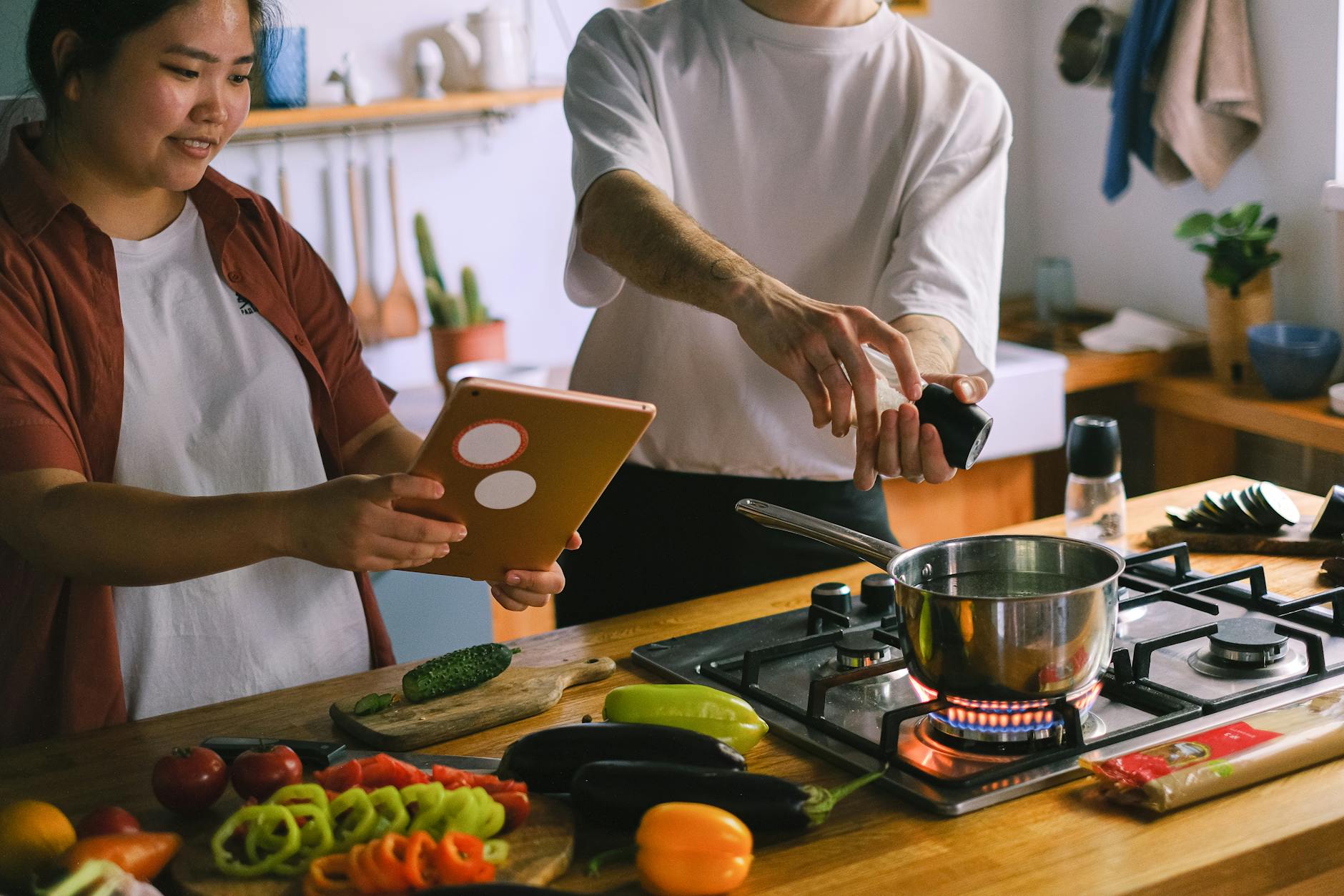 Young couple cooking together in modern kitchen during cooking class