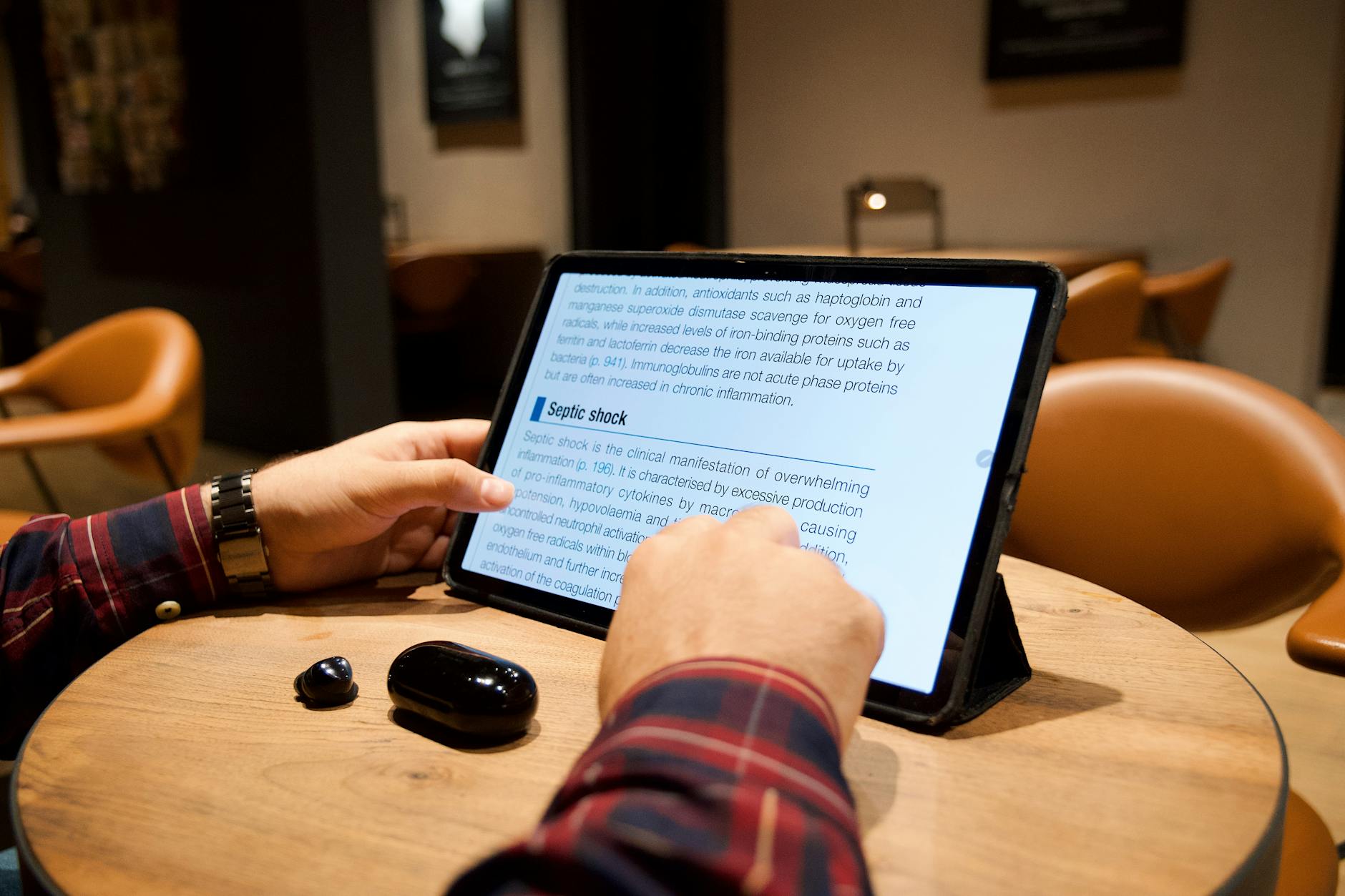 Person reading an e-book on tablet device showing digital reading interface