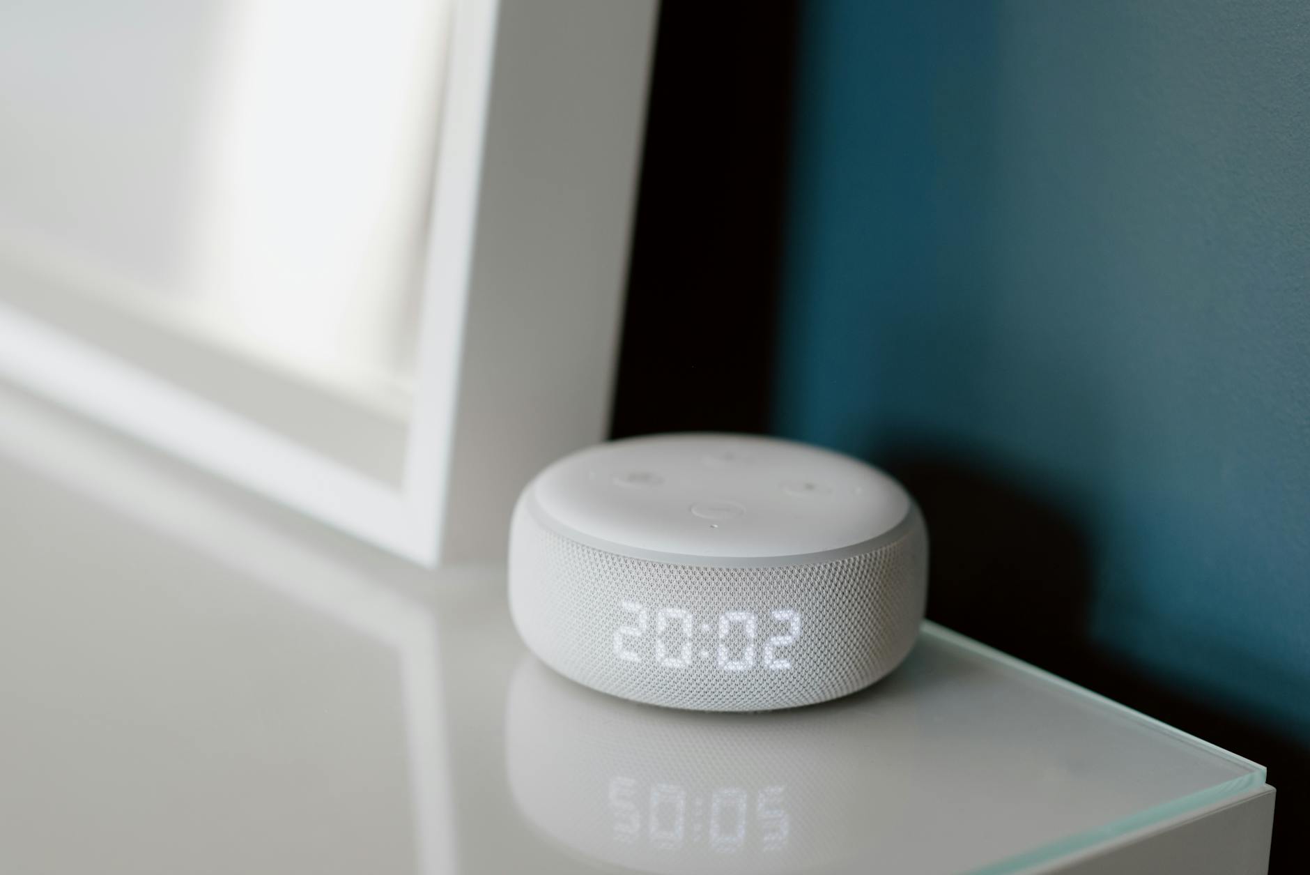 Modern smart home hub device on a living room table with clean, minimalist design
