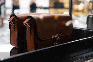 Collection of luxury designer handbags displayed on shelves