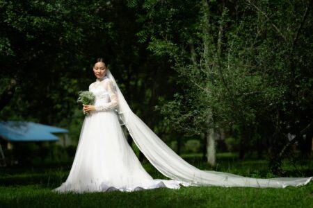 Elegant white wedding dress hanging in bridal boutique