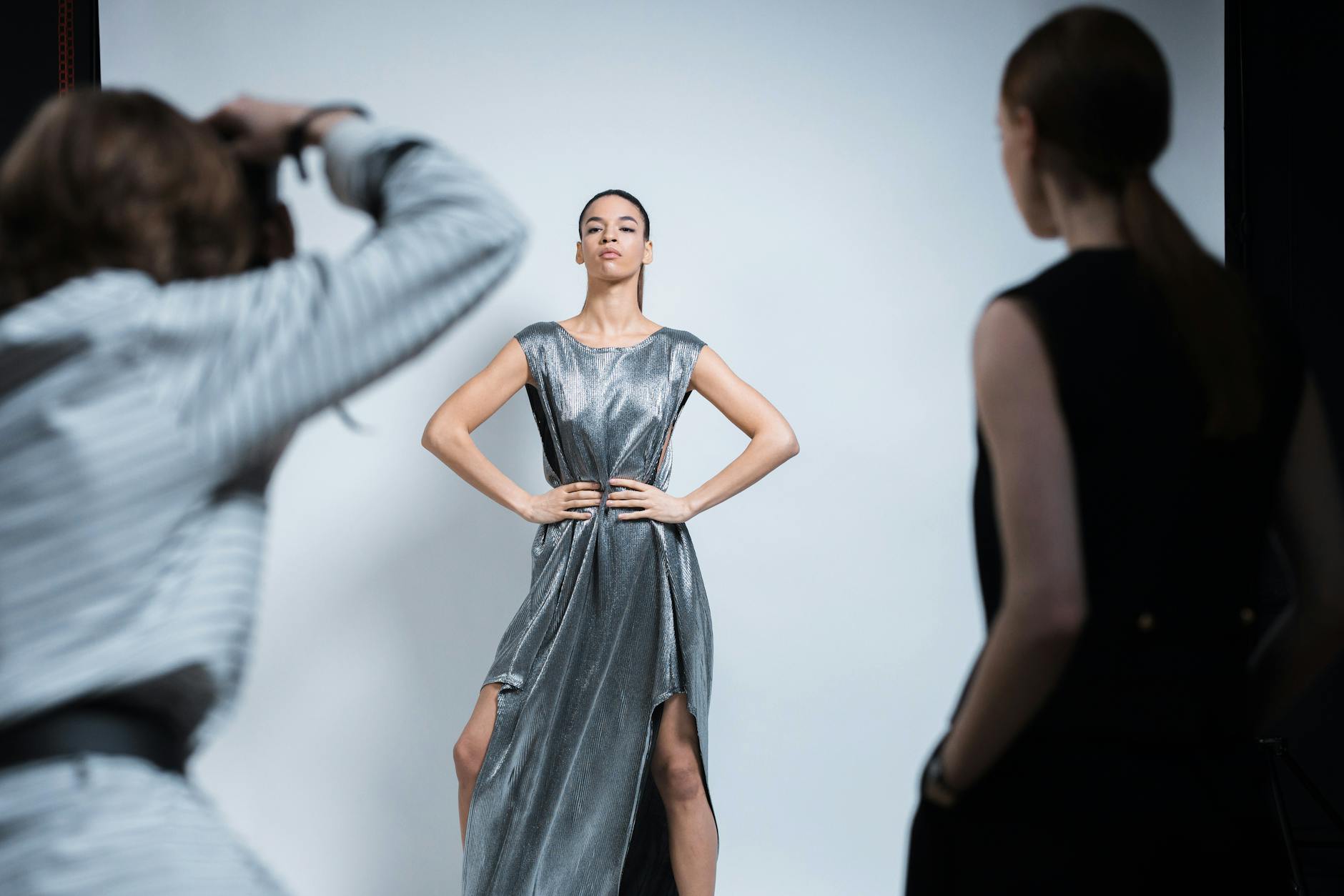 Modern fashion design studio with clothing racks, mirrors, and professional lighting equipment