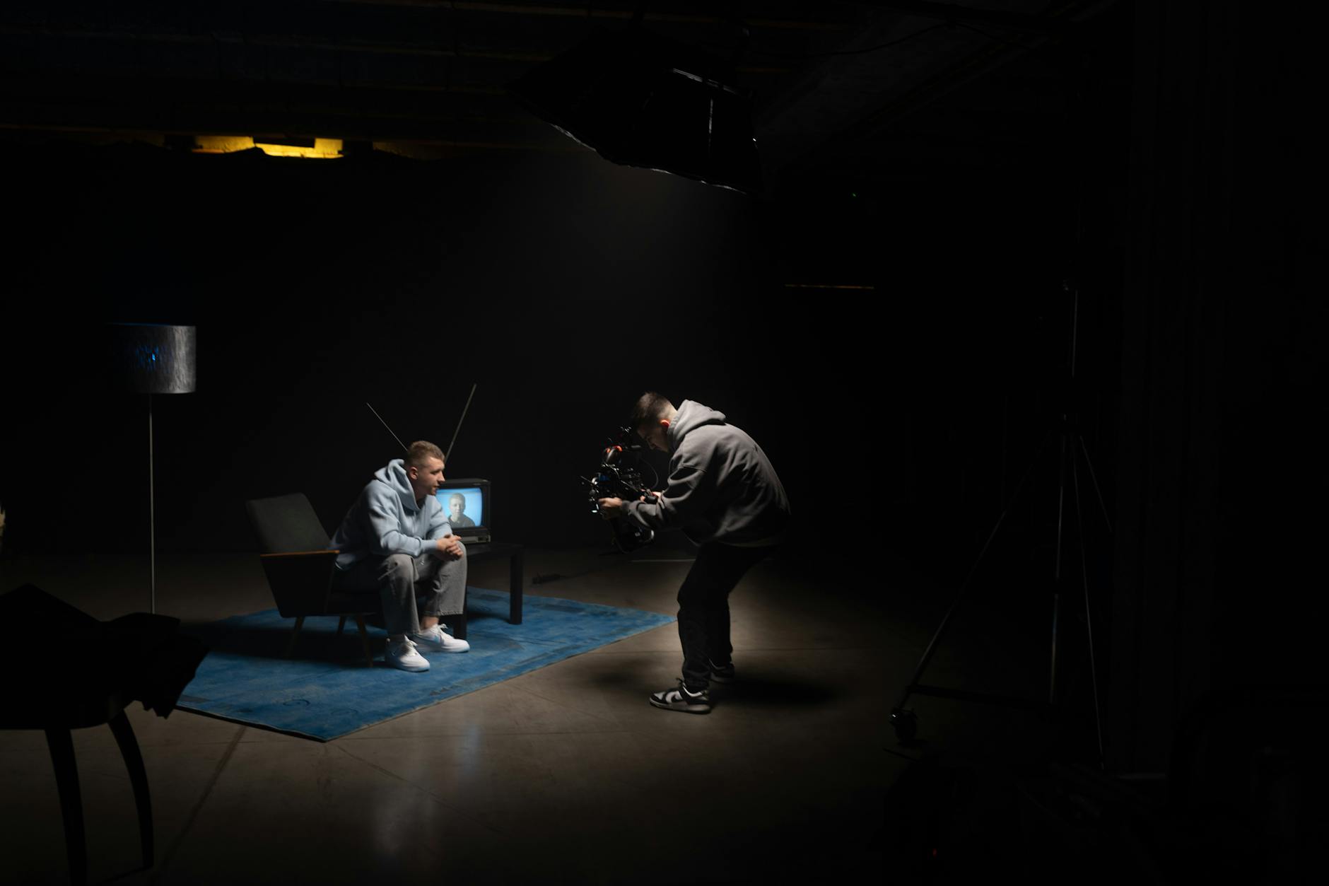 Behind-the-scenes view of a television or film production set with cameras and lighting equipment