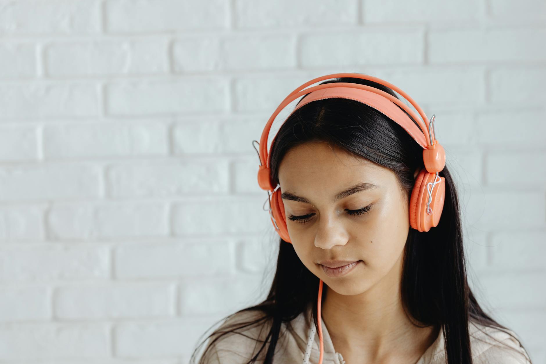 Person wearing headphones while listening to audio content