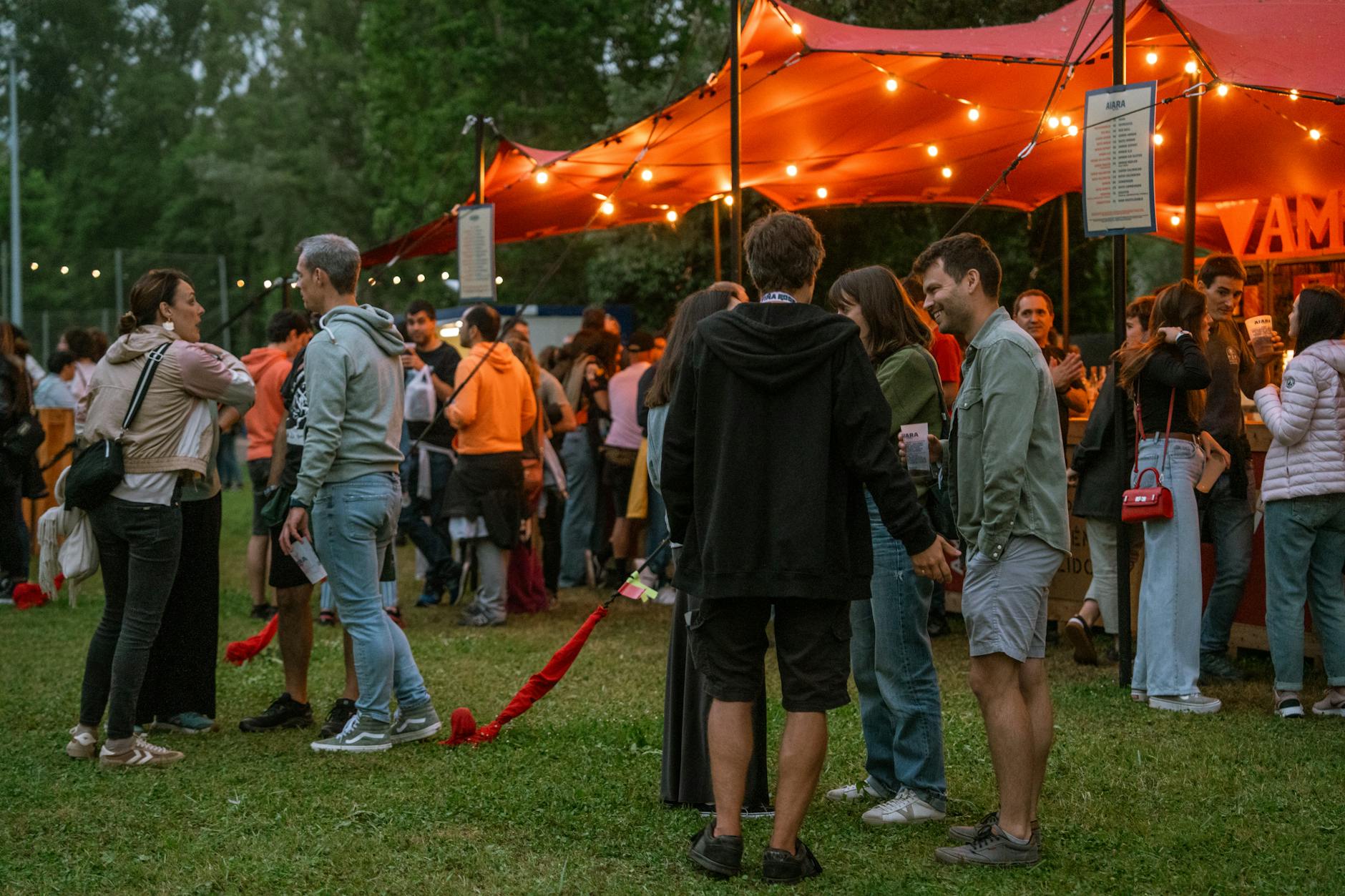 Group of well-dressed adults mingling and conversing at an upscale social gathering or networking event